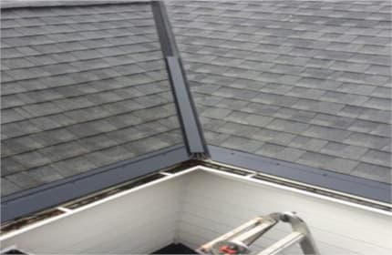 Dark bronze valley and eave panels match roof color