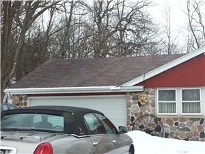 This homeowner covered his gutter with sheet metal in an attempt to prevent ice dams in Wales, WI