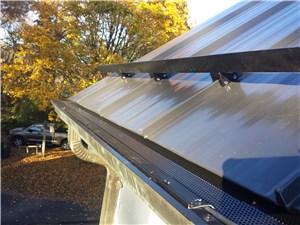VersaScreen IceBlaster DE heated gutter guard on a standing seam metal roof with snow retention system
