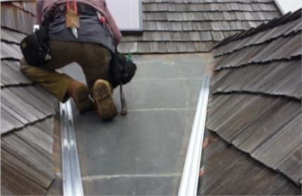 Installing base extrusion in a radiant heat panel for ice dam prevention in Southeastern Wisconsin
